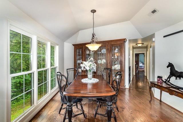 dining area with dark hardwood / wood-style flooring and vaulted ceiling