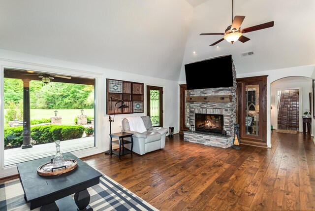 884 Pinnacle Hill Rd, Kingston Springs, TN 37082 - living area with ceiling fan, arched walkways, high vaulted ceiling, dark wood-type flooring, and a stone fireplace