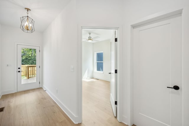 interior space with light hardwood / wood-style floors and a chandelier