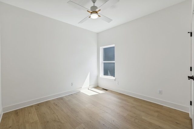 empty room with ceiling fan and light hardwood / wood-style flooring