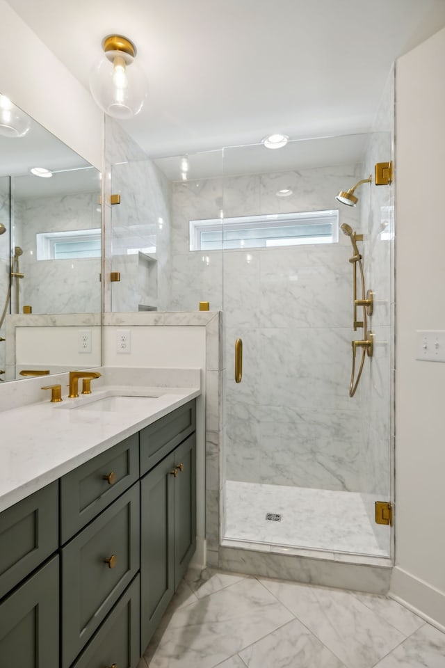 bathroom with vanity and a shower with door