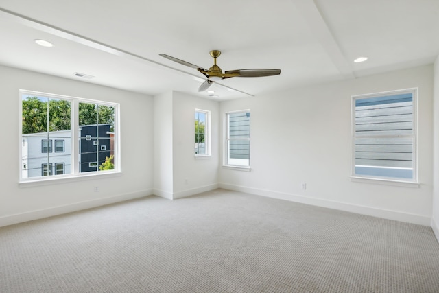 carpeted empty room with plenty of natural light and ceiling fan