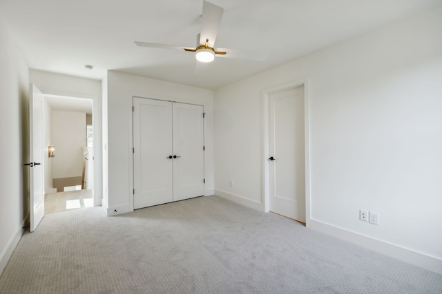 unfurnished bedroom featuring light colored carpet and ceiling fan