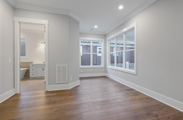 empty room with hardwood / wood-style flooring and ornamental molding