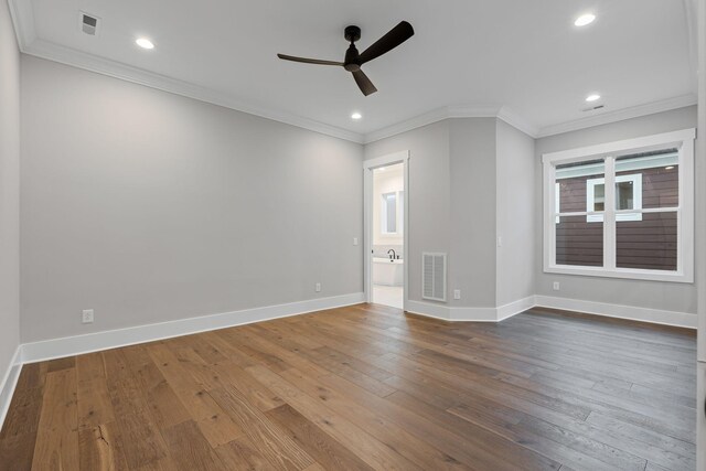 spare room with wood-type flooring, ornamental molding, and ceiling fan