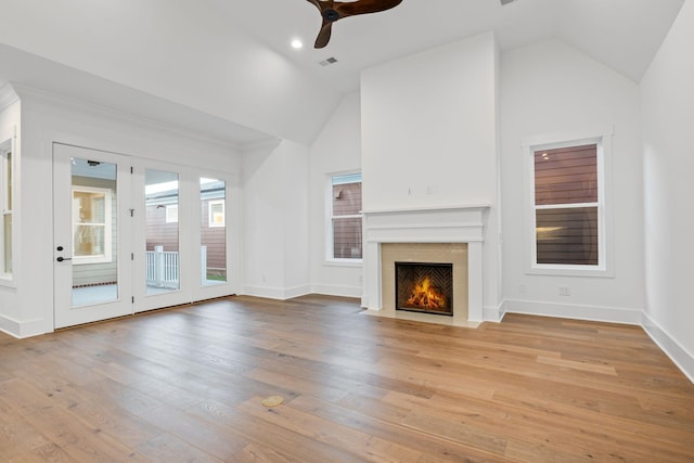 unfurnished living room featuring lofted ceiling, light hardwood / wood-style flooring, and ceiling fan