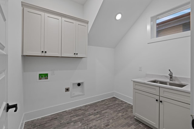 clothes washing area with cabinets, hookup for an electric dryer, hookup for a washing machine, and sink