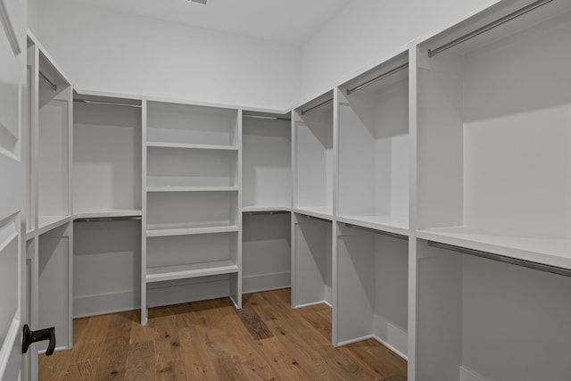 walk in closet with wood-type flooring