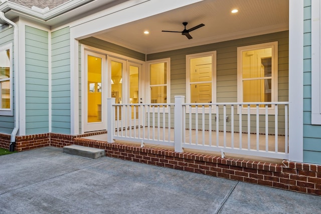 entrance to property with ceiling fan and a patio area