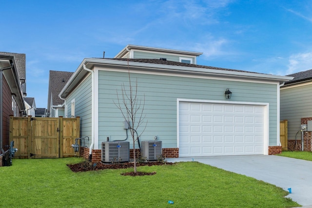 exterior space featuring cooling unit, a garage, and a yard