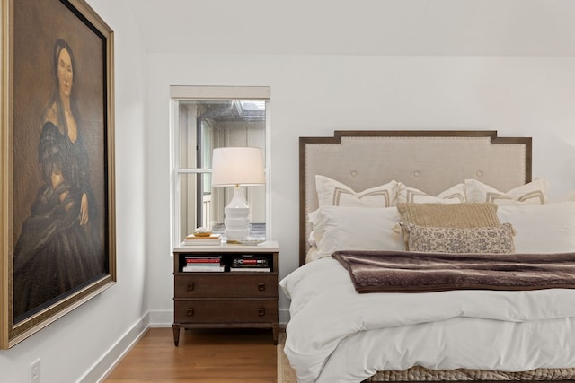 bedroom with hardwood / wood-style floors