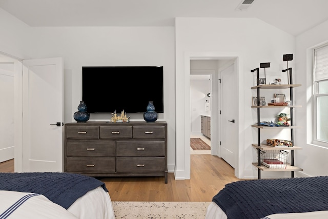 bedroom with light hardwood / wood-style flooring and vaulted ceiling