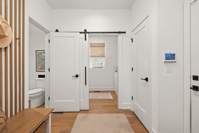 bathroom with hardwood / wood-style flooring and toilet