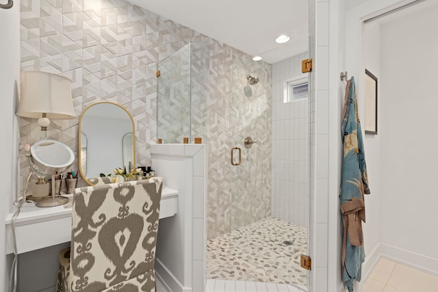 bathroom featuring a shower with shower door, tile patterned floors, and tile walls