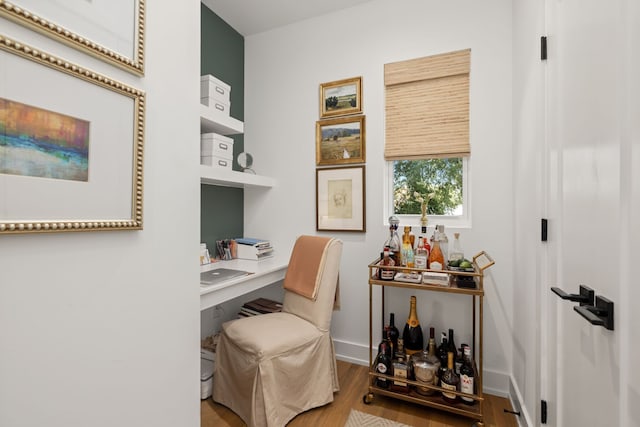 office featuring light hardwood / wood-style floors and built in desk