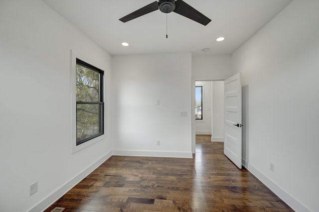 unfurnished room with ceiling fan and dark hardwood / wood-style floors