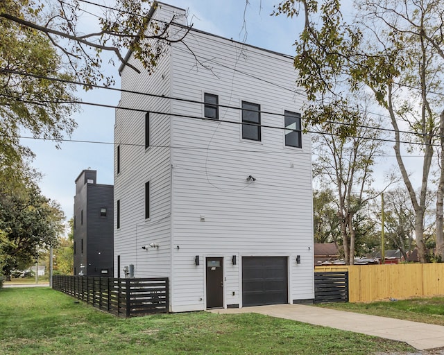 exterior space featuring a garage and a front yard