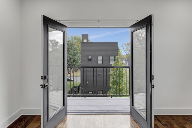 entryway with french doors and wood-type flooring