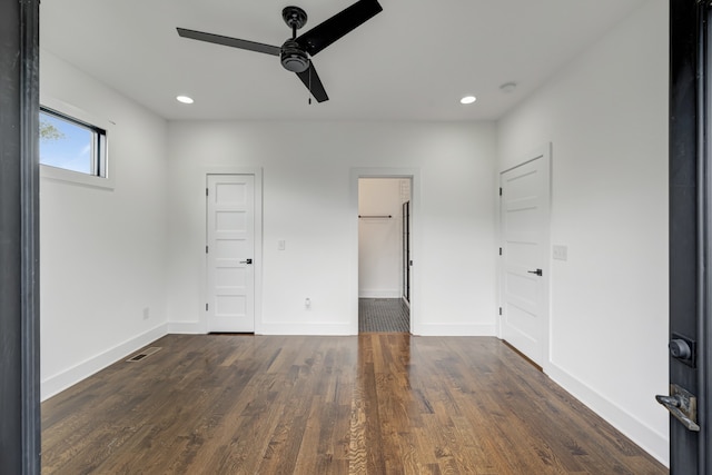 unfurnished bedroom featuring dark wood-type flooring and ceiling fan