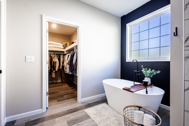 bathroom featuring a washtub and hardwood / wood-style flooring