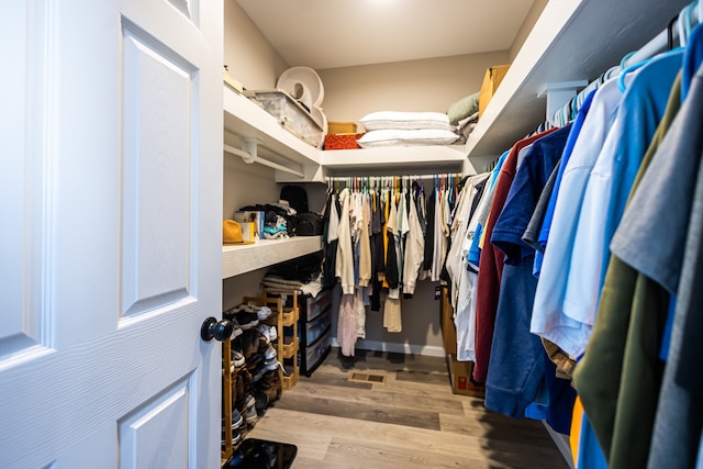 spacious closet featuring light hardwood / wood-style flooring