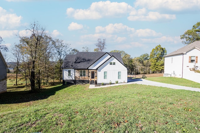 rear view of house featuring a lawn