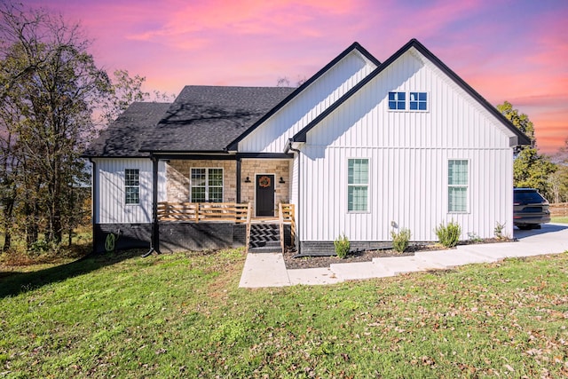 modern farmhouse with a lawn