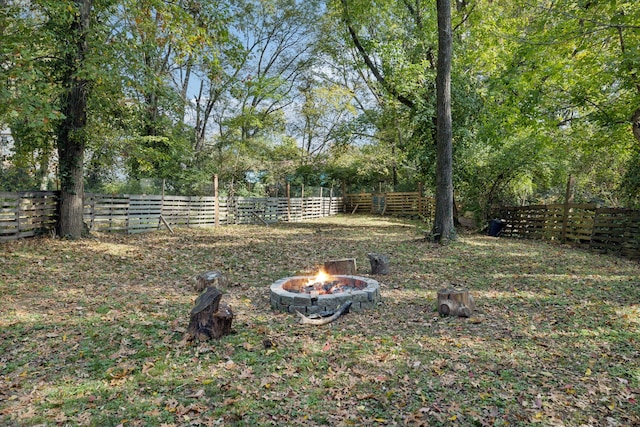 view of yard with a fire pit