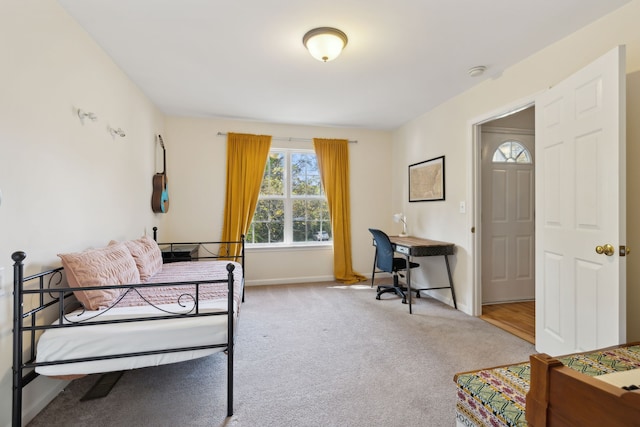 bedroom featuring light carpet