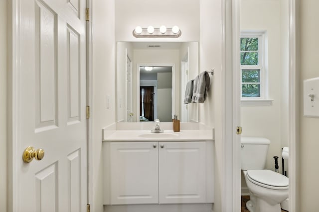 bathroom featuring vanity and toilet