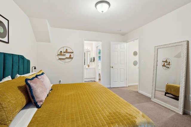 bedroom featuring light carpet and connected bathroom