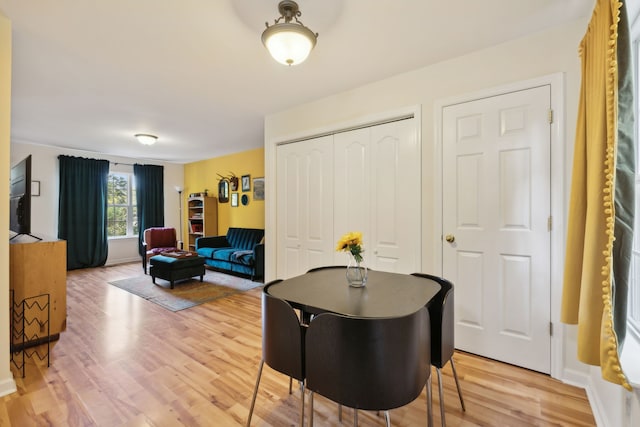 dining space with hardwood / wood-style flooring