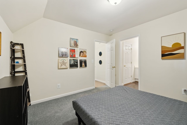 bedroom with lofted ceiling and dark carpet