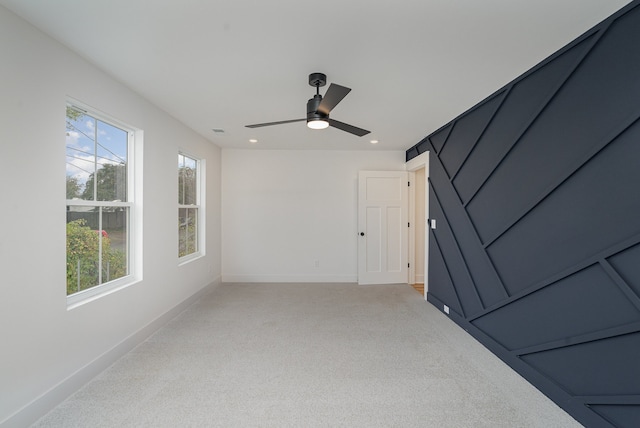 interior space featuring ceiling fan and light colored carpet