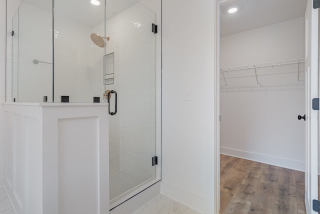 bathroom featuring walk in shower and hardwood / wood-style floors