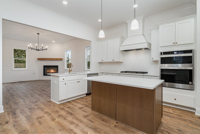 kitchen with white cabinetry, light wood-type flooring, and kitchen peninsula