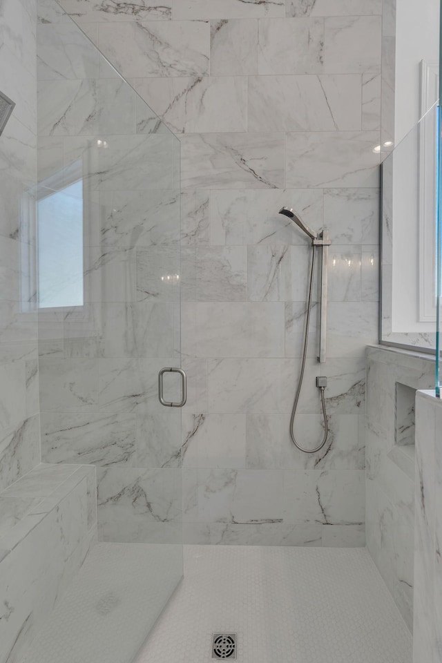 full bathroom featuring a marble finish shower