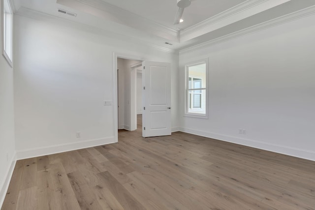 empty room featuring baseboards, visible vents, ornamental molding, wood finished floors, and recessed lighting