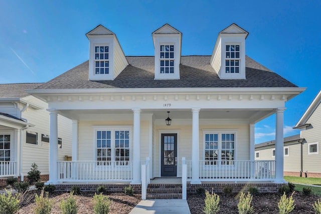 view of front of house featuring covered porch and roof with shingles