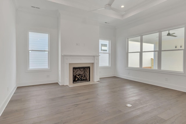 unfurnished living room featuring ornamental molding, a fireplace, ceiling fan, and wood finished floors