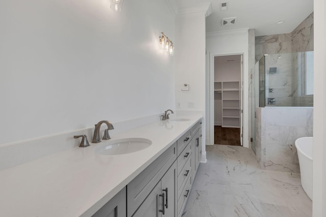 bathroom with marble finish floor, a marble finish shower, a walk in closet, and a sink