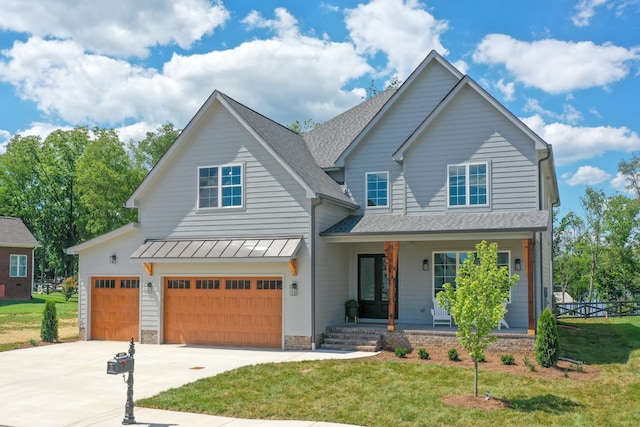 view of front of property with a front yard, a porch, and a garage