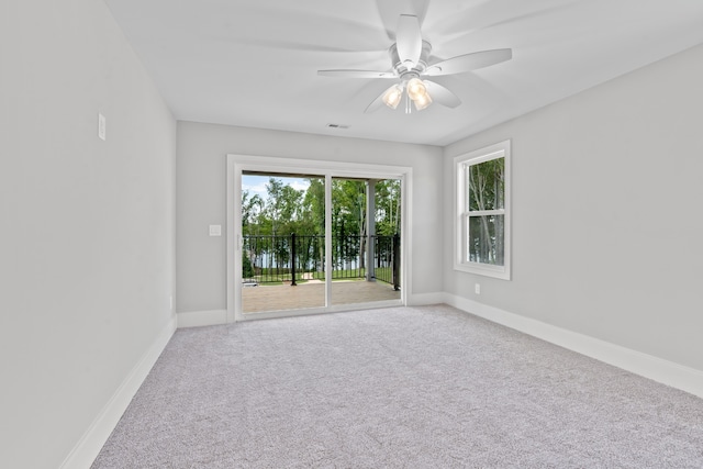 empty room with carpet flooring and ceiling fan