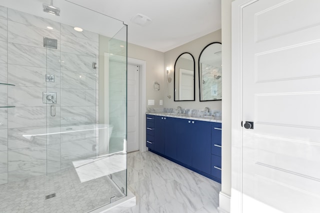 bathroom featuring vanity and a shower with shower door