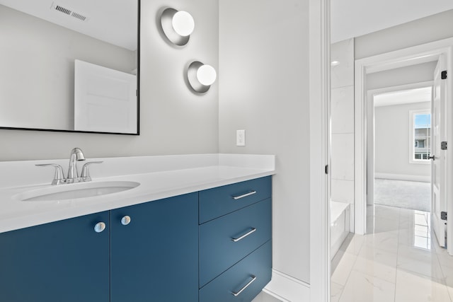 bathroom featuring a tub to relax in and vanity