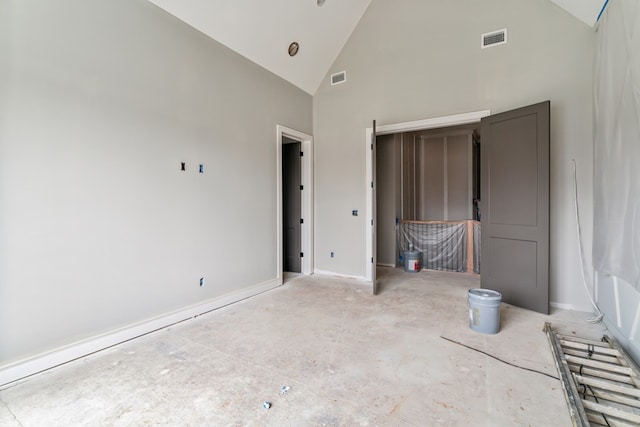 unfurnished bedroom with high vaulted ceiling