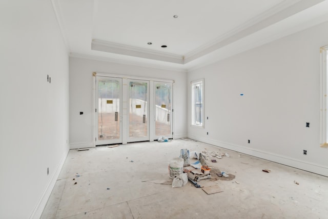 empty room with a tray ceiling and crown molding