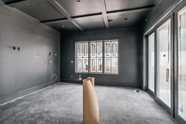 spare room featuring beamed ceiling and coffered ceiling