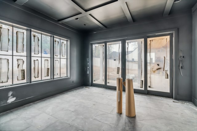 empty room featuring beamed ceiling and coffered ceiling