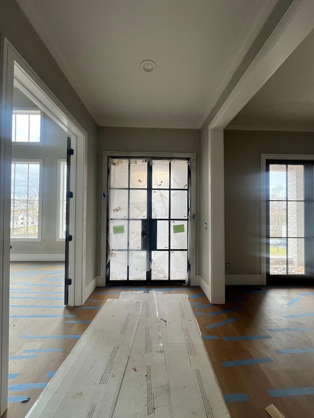 doorway featuring french doors, ornamental molding, and baseboards